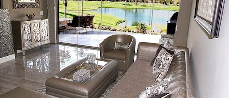 Modern "Hollywood Glam" Living Room overlooks view of lake/golf course/mountains