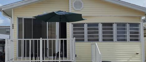 Front of house with nice table to relax and see the neighbors, large driveway