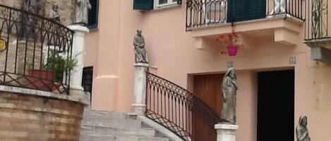 Front of house. Separate guest entrance is the wooden door on the left.