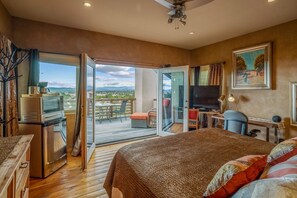 Master suite with a king bed, desk, kitchenette, deck