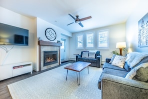 Living area - Gas fireplace, queen size sofa sleeper, access to private balcony, and newly upgraded 55" smart TV.