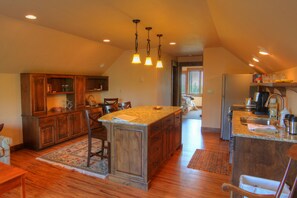 kitchen, great room, bedroom & bath at back