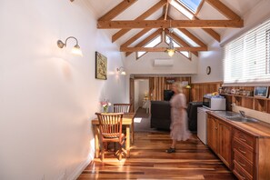 The dining/kitchenette and living room area with cathedral ceiling and skylights