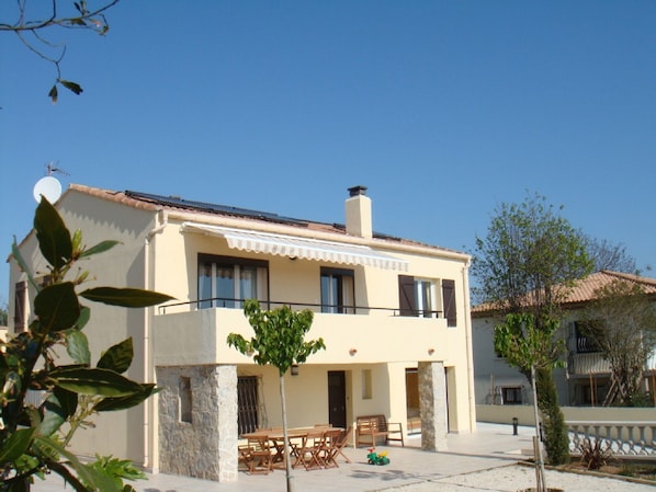 Front view of villa with BBQ area and terrace