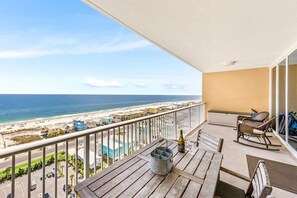 30' balcony with comfortable chairs and outdoor dining for 4