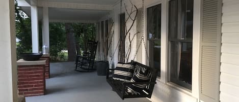 Front porch with rocking chairs and swing