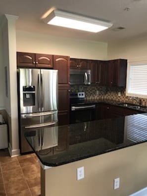 Brand new kitchen with sparkling stainless steel appliances