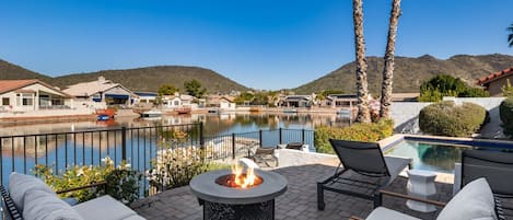 Relax on the outdoor sectional taking in the beautiful lakefront and mountain vistas by the firepit.