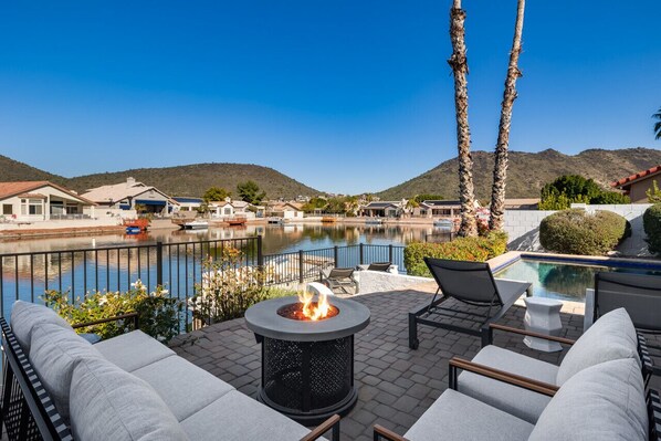 Relax on the outdoor sectional taking in the beautiful lakefront and mountain vistas by the firepit.