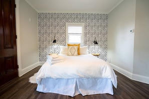 The room features a plush queen bed.