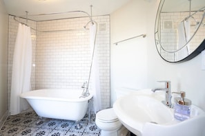 The bathroom fills with an abundance of light and has a beautiful clawfoot bath tub.