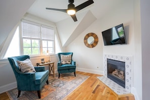 The room has its own seating area and fireplace.