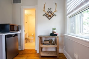 The room includes a microwave and mini fridge.