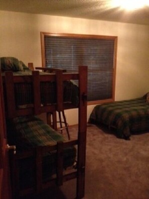 5th bedroom with bunk beds and two single beds