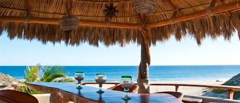 Enjoy the Breeze under the Palapa at the Outside Bar