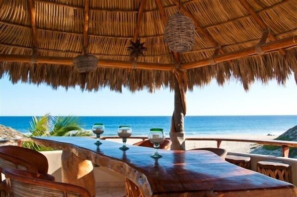 Enjoy the Breeze under the Palapa at the Outside Bar