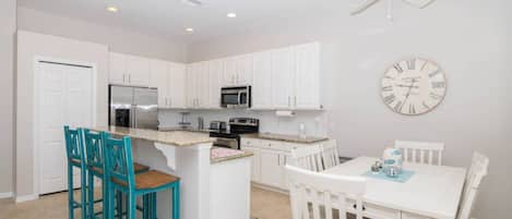 The Kitchen of the Home Has Stainless Steel Appliances and Granite Counter Tops.