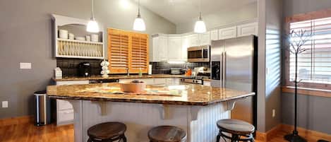 Gourmet Kitchen with Breakfast Bar and Granite Counter-tops
