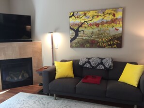Open floor plan main floor with  55' HDTV and gas fireplace