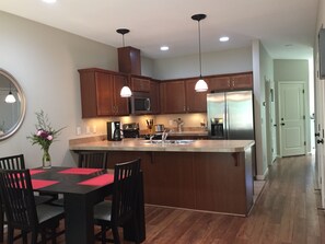 Dining table is set for 4 to 6 but expands to seat 10