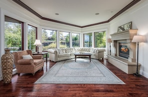 Living room w/ large picture windows to view Mirror Pond & Drake Park.