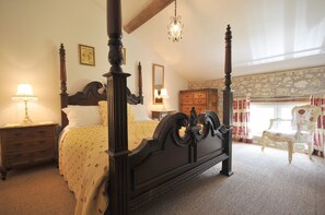 Four-poster with adjacent shower room.