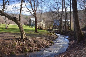 Enjoy the babbling brook from the large yard behind the houses.  The deck of the cottage has a grill so even the cook enjoys the scene.