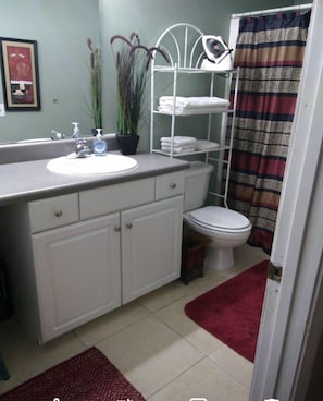 Full bathroom with walk in shower and a built in shower seat