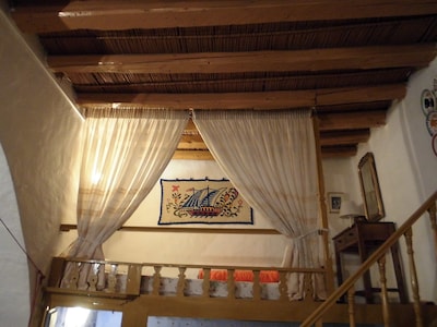 The Swallows' Nest:-Traditional Greek house with soaring central arch, and lofts