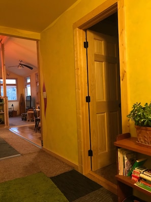 Entry foyer. Bedroom to right, laundry to left, great room/kitchen beyond.