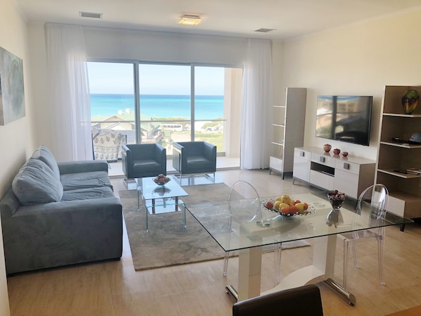 Living Room has an access to the balcony with the sea, pool and garden view!