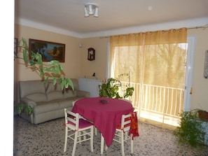 The living room with its balcony and view from the garden