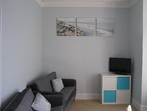 Living room area with 2 sofas and TV with Freeview.