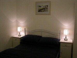 Bedroom One - with double bed, side tables, wardrobe and dressing table.