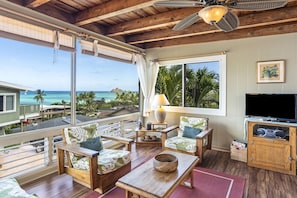 Large windows frame the pacific and Mokulua Islands