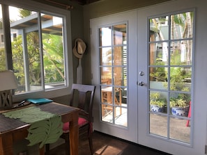 Inviting ambient lighting french doors. Inside or outside dining for up to four