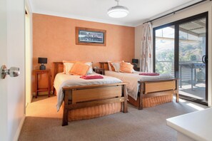 2nd bedroom with 2 king single beds and access to balcony