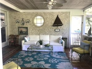 Enjoy morning coffee on the screen porch. String lights gives this space warmth