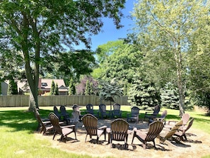 OUTDOOR FIRE PIT: behind pool fence, adirondack chairs, hammock, farmland views