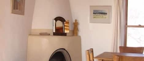 Wood burning kiva fireplace and dining area