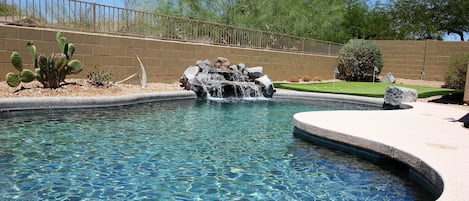 Private backyard with pool and putting green