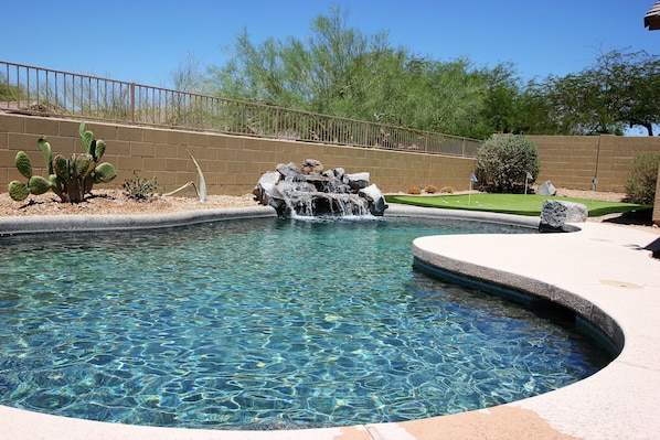 Private backyard with pool and putting green