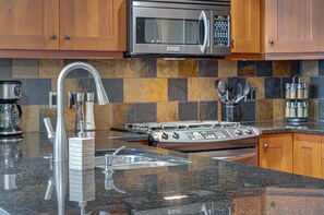 Cherry wood cabinets and natural slate throughout