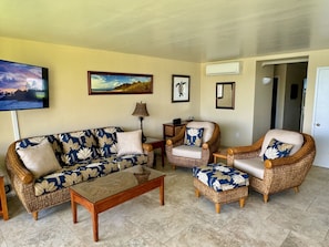 The living room has tasteful, Hawaiian-inspired furniture - brand new in 2023!