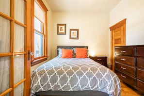 Master Bedroom off of living room through 2 french doors. High ceilings, light