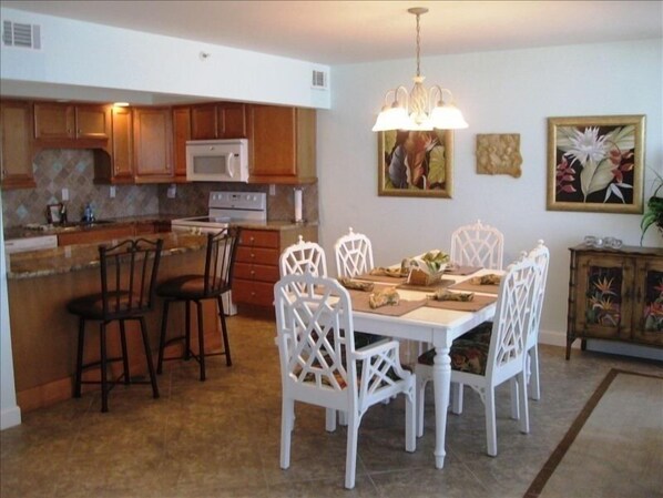 Dining room/kitchen, next to the den, with floor-to-ceiling windows & balcony!