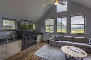 Comfy living room with huge flat screen SmartTV, gas fireplace and sectional
