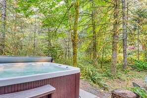 Hot tub opens to large back yard that backs up to acres of private woods.