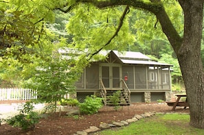 Wildflower beds & paths around cabin.
