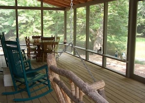 Creek winds around side & front of huge screened porch.